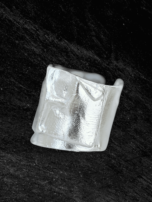 “Imprinta Ring by RABIES DOG, crafted in S925 sterling silver with a textured surface on a dark background.”