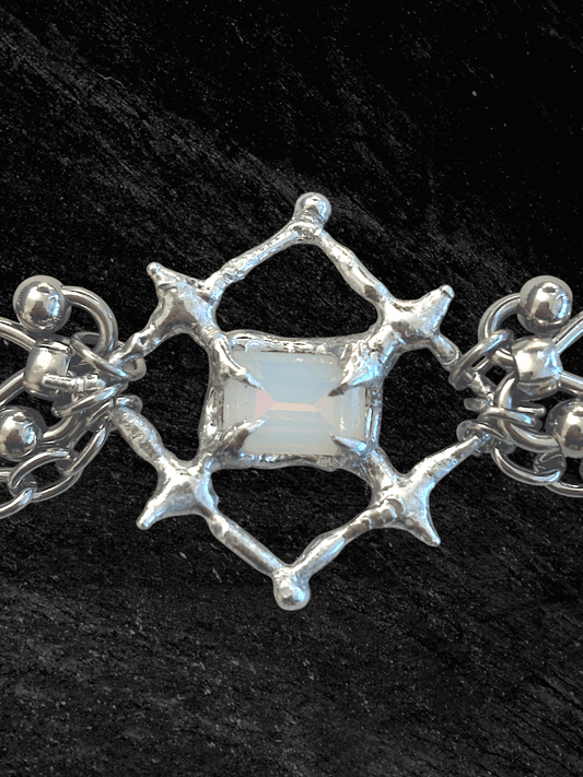 The Angel’s Eye Necklace is a sculptural statement piece inspired by sacred symbolism and watchful, otherworldly forms. Handcrafted by RABIES DOG, it carries a quiet tension between protection and unease