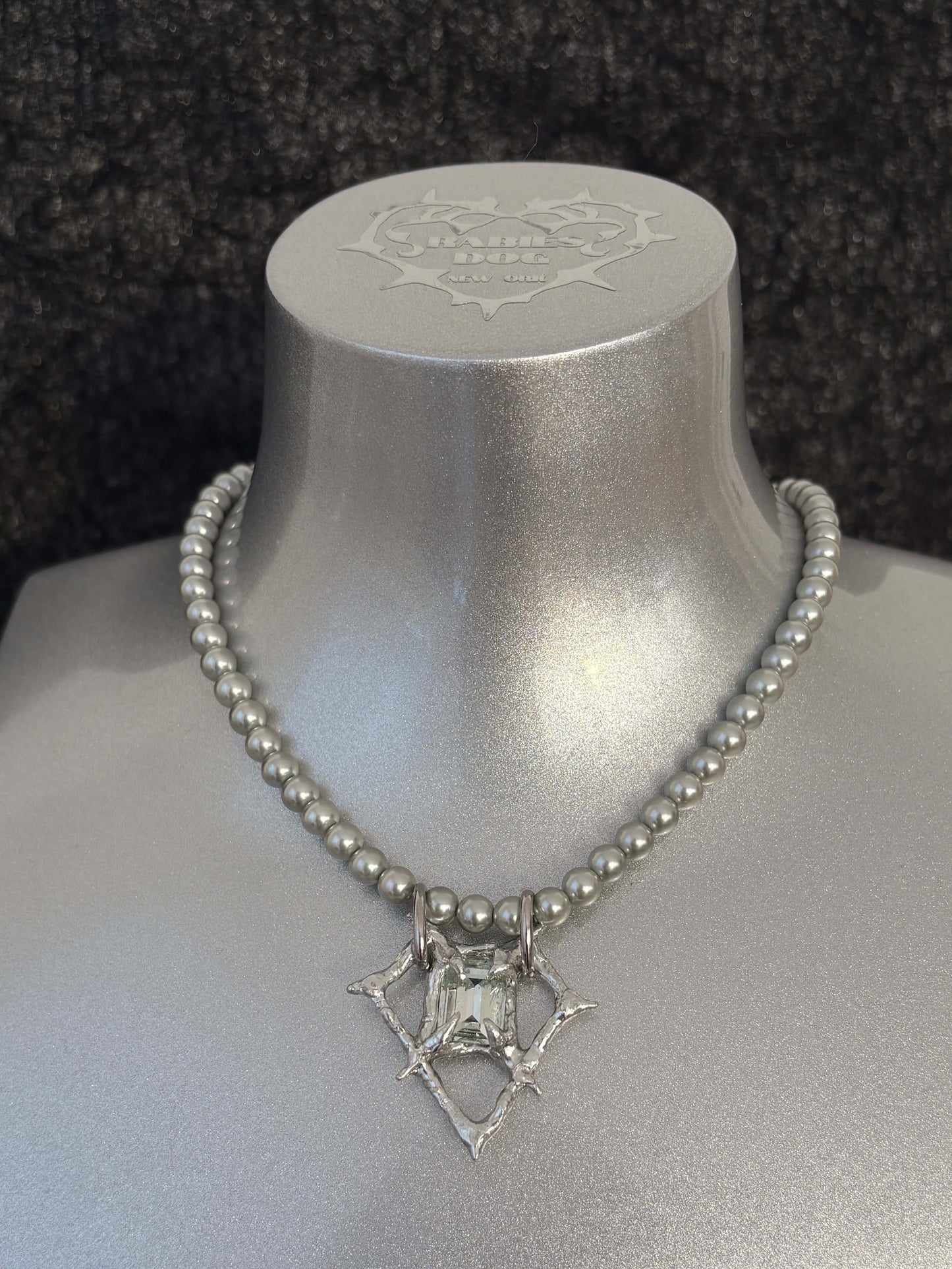 RABIES DOG Oracle necklace, a soldered crystal talisman worn on a pearl-like chain with an organic sculptural finish