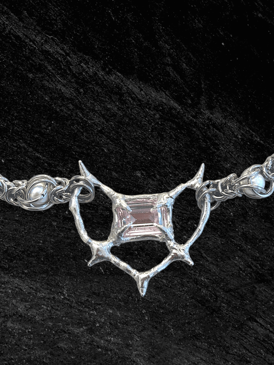 Pearl Antler necklace by RABIES DOG, handcrafted soldered metal necklace with pearls and organic antler-inspired form, front view on dark background