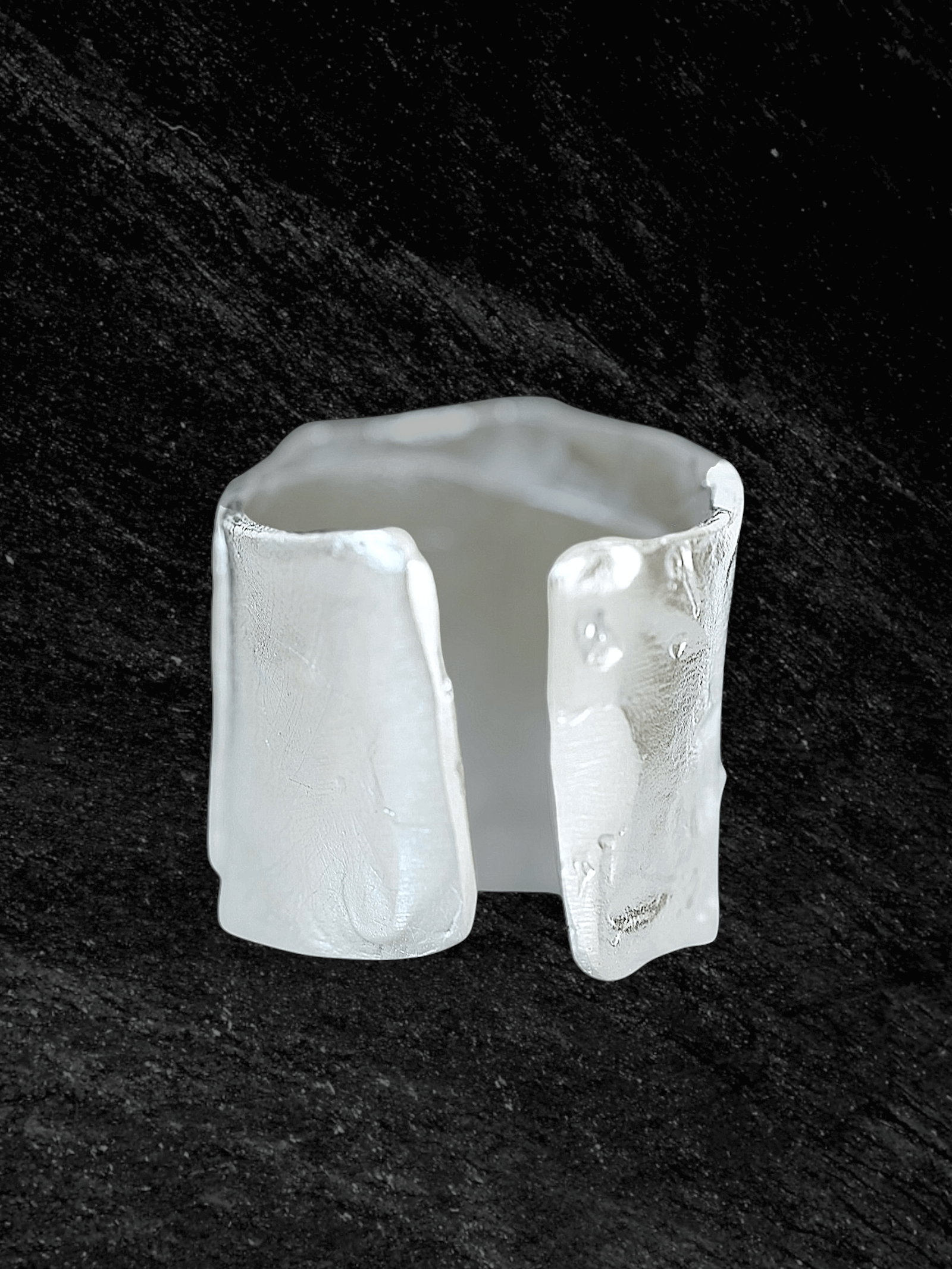 “Imprinta Ring by RABIES DOG, crafted in S925 sterling silver with a textured surface on a dark background.”