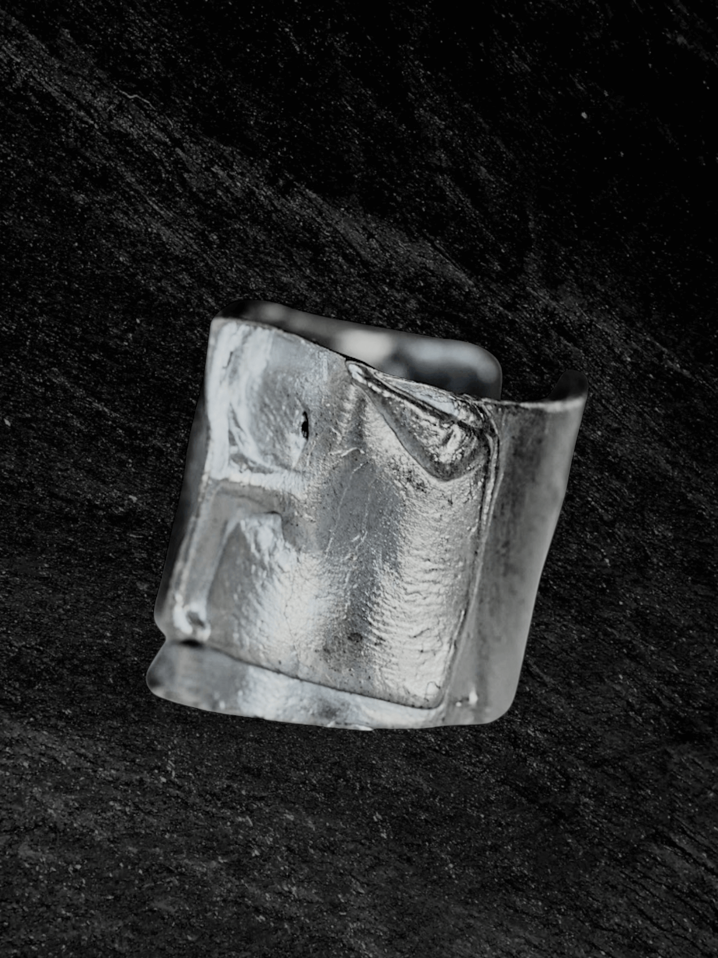 “Imprinta Ring by RABIES DOG, crafted in S925 sterling silver with a textured surface on a dark background.”