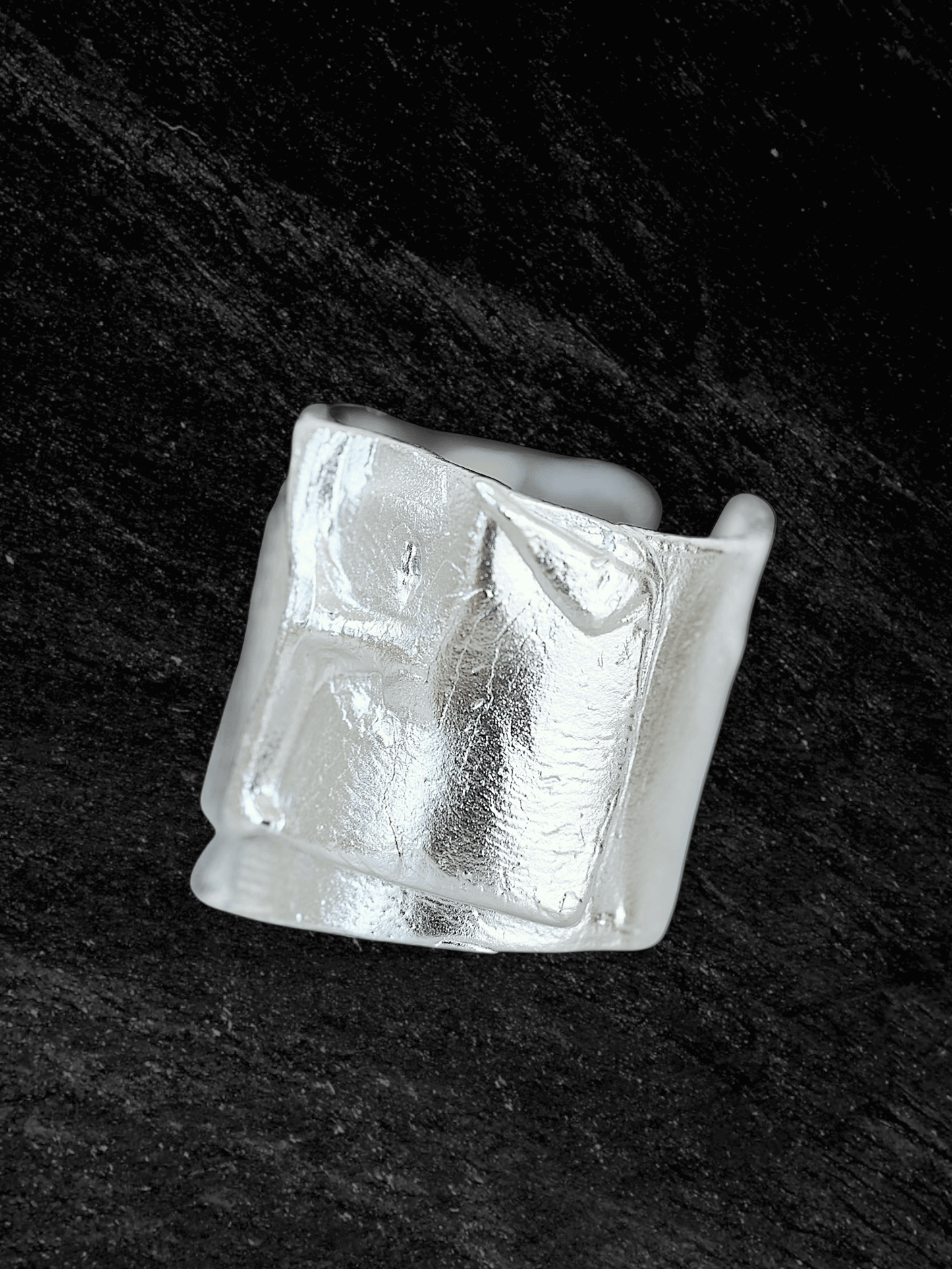 “Imprinta Ring by RABIES DOG, crafted in S925 sterling silver with a textured surface on a dark background.”