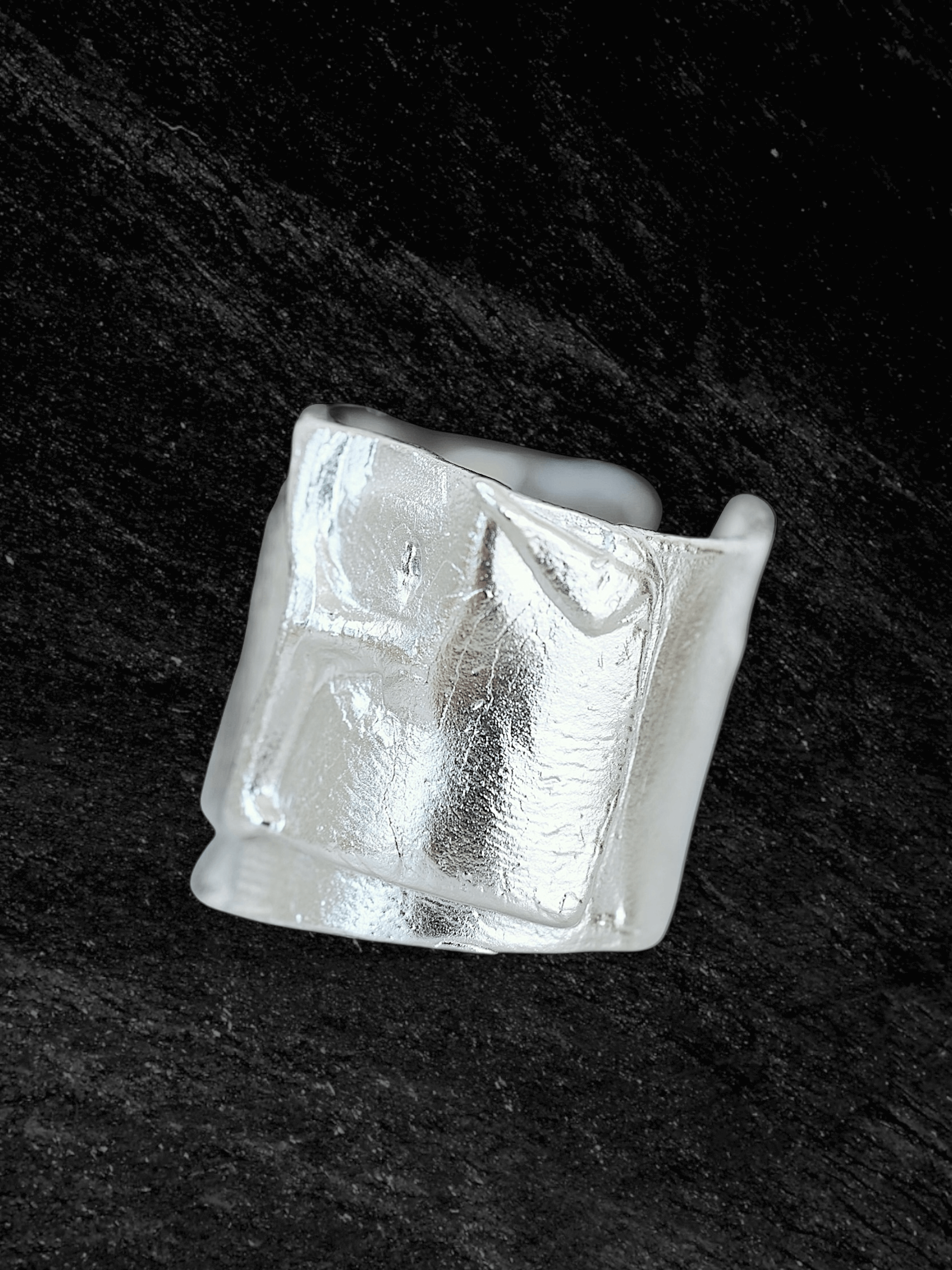 “Imprinta Ring by RABIES DOG, crafted in S925 sterling silver with a textured surface on a dark background.”