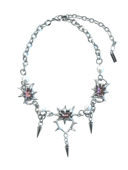 The Midnight Candelabrum Necklace is a sculptural statement piece inspired by gothic candleholders and nocturnal ritual objects. Handcrafted by RABIES DOG, this necklace carries a dark, altar-like presence—designed to be worn as both adornment and symbol.