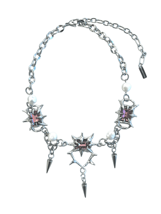 The Midnight Candelabrum Necklace is a sculptural statement piece inspired by gothic candleholders and nocturnal ritual objects. Handcrafted by RABIES DOG, this necklace carries a dark, altar-like presence—designed to be worn as both adornment and symbol.