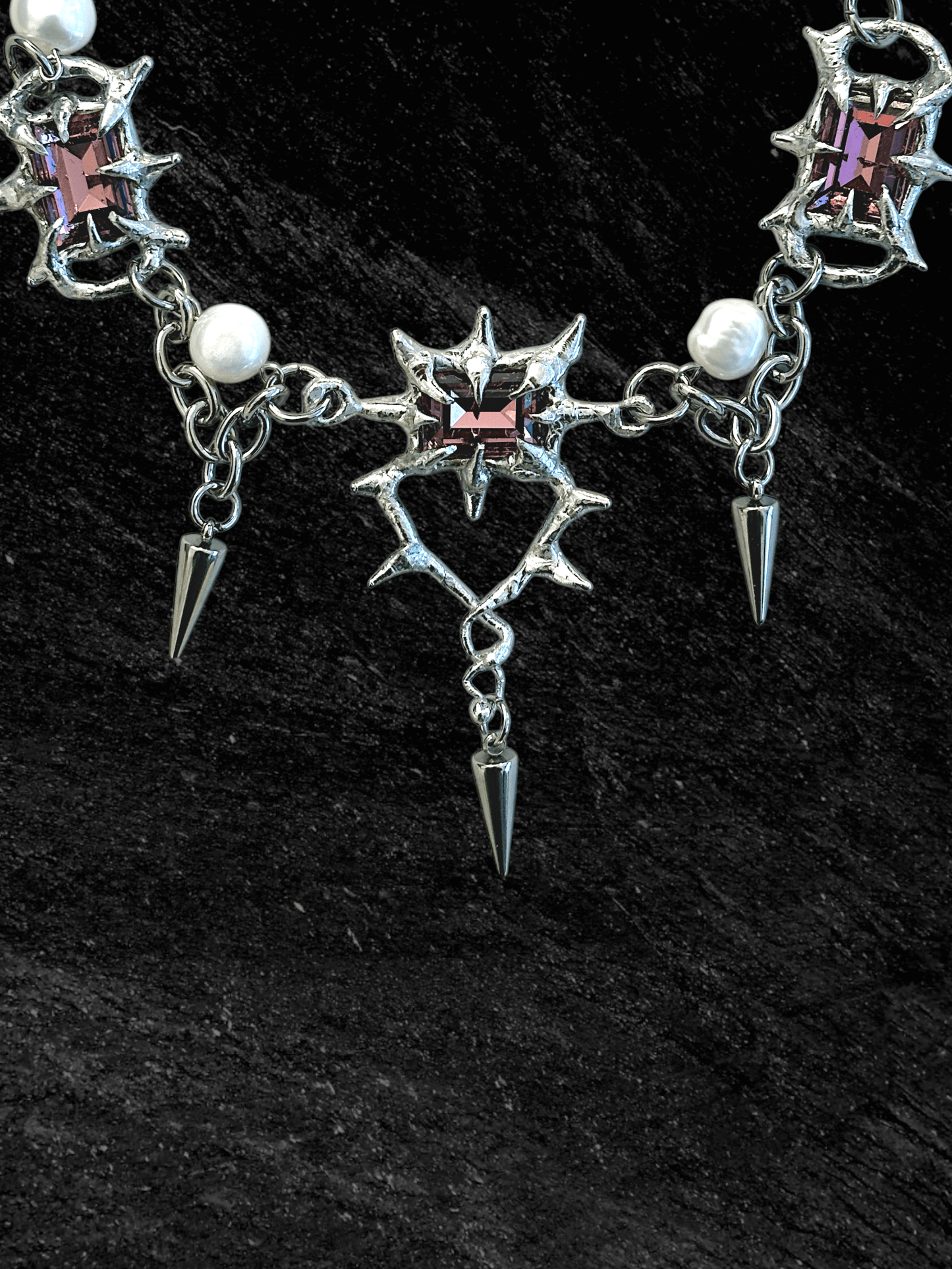 The Midnight Candelabrum Necklace is a sculptural statement piece inspired by gothic candleholders and nocturnal ritual objects. Handcrafted by RABIES DOG, this necklace carries a dark, altar-like presence—designed to be worn as both adornment and symbol.