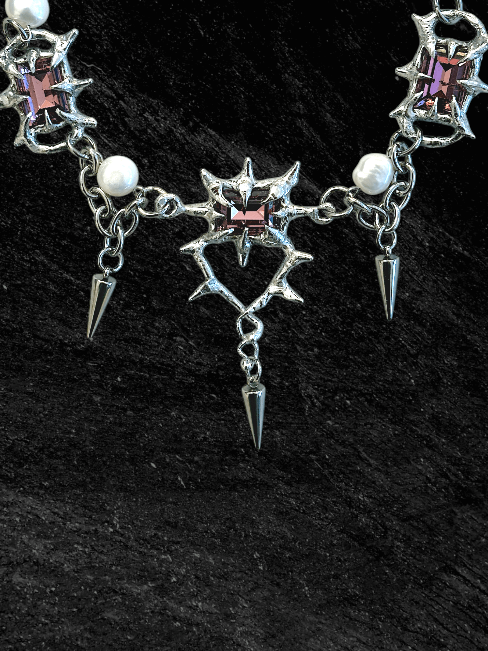 The Midnight Candelabrum Necklace is a sculptural statement piece inspired by gothic candleholders and nocturnal ritual objects. Handcrafted by RABIES DOG, this necklace carries a dark, altar-like presence—designed to be worn as both adornment and symbol.