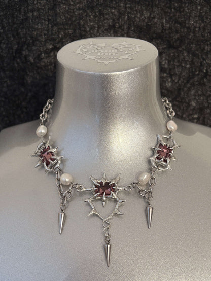 The Midnight Candelabrum Necklace is a sculptural statement piece inspired by gothic candleholders and nocturnal ritual objects. Handcrafted by RABIES DOG, this necklace carries a dark, altar-like presence—designed to be worn as both adornment and symbol.