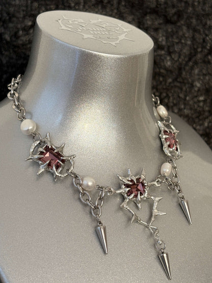 The Midnight Candelabrum Necklace is a sculptural statement piece inspired by gothic candleholders and nocturnal ritual objects. Handcrafted by RABIES DOG, this necklace carries a dark, altar-like presence—designed to be worn as both adornment and symbol.