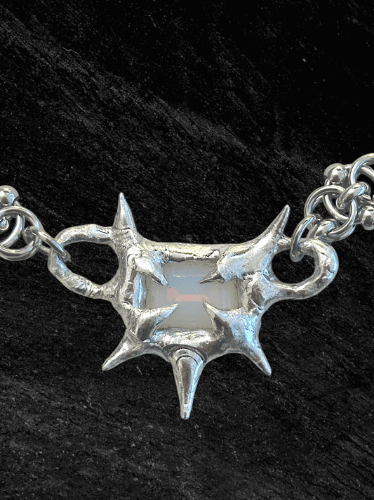 “Softlight Crystal Necklace by RABIES DOG, handcrafted with a soldered setting and a soft-glow crystal accent.”