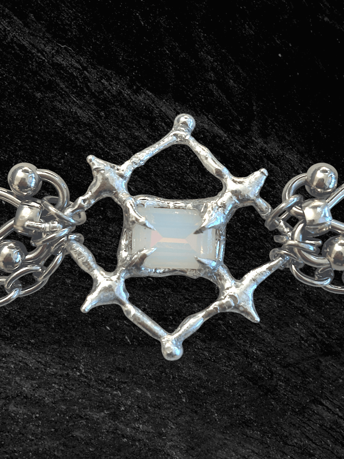 The Angel’s Eye Necklace is a sculptural statement piece inspired by sacred symbolism and watchful, otherworldly forms. Handcrafted by RABIES DOG, it carries a quiet tension between protection and unease