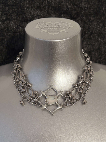 The Angel’s Eye Necklace is a sculptural statement piece inspired by sacred symbolism and watchful, otherworldly forms. Handcrafted by RABIES DOG, it carries a quiet tension between protection and unease