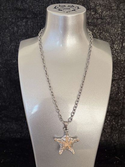 “Littlestarfish Necklace by RABIES DOG, featuring a real starfish, carefully soldered and UV sealed for preservation.”